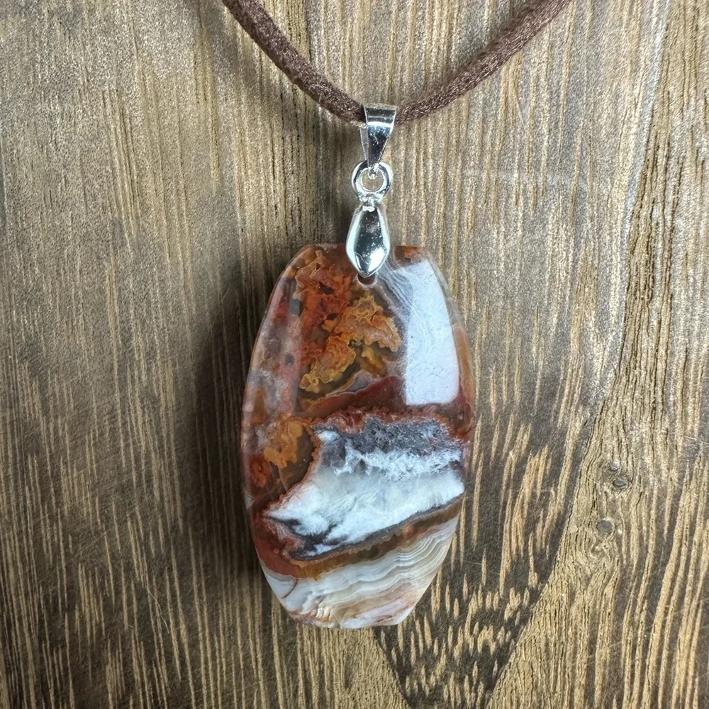 Mexican Crazy Lace Agate Pendant Necklace on Dark Brown Faux Suede